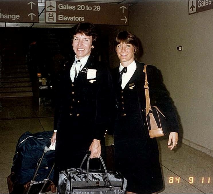 1984 September 11, Two Pan Am flight attendants pose for a photo while in transit at an airport, location unknown.